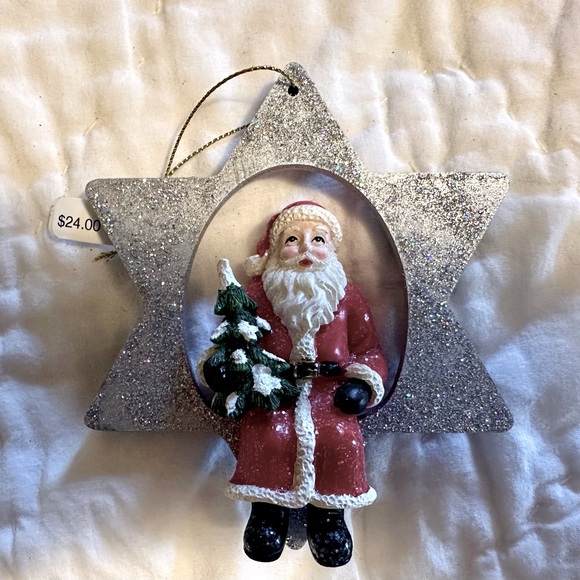 A Glittering Silver Star Christmas Ornament with a jolly Santa holding a Tree - Picture 1 of 6